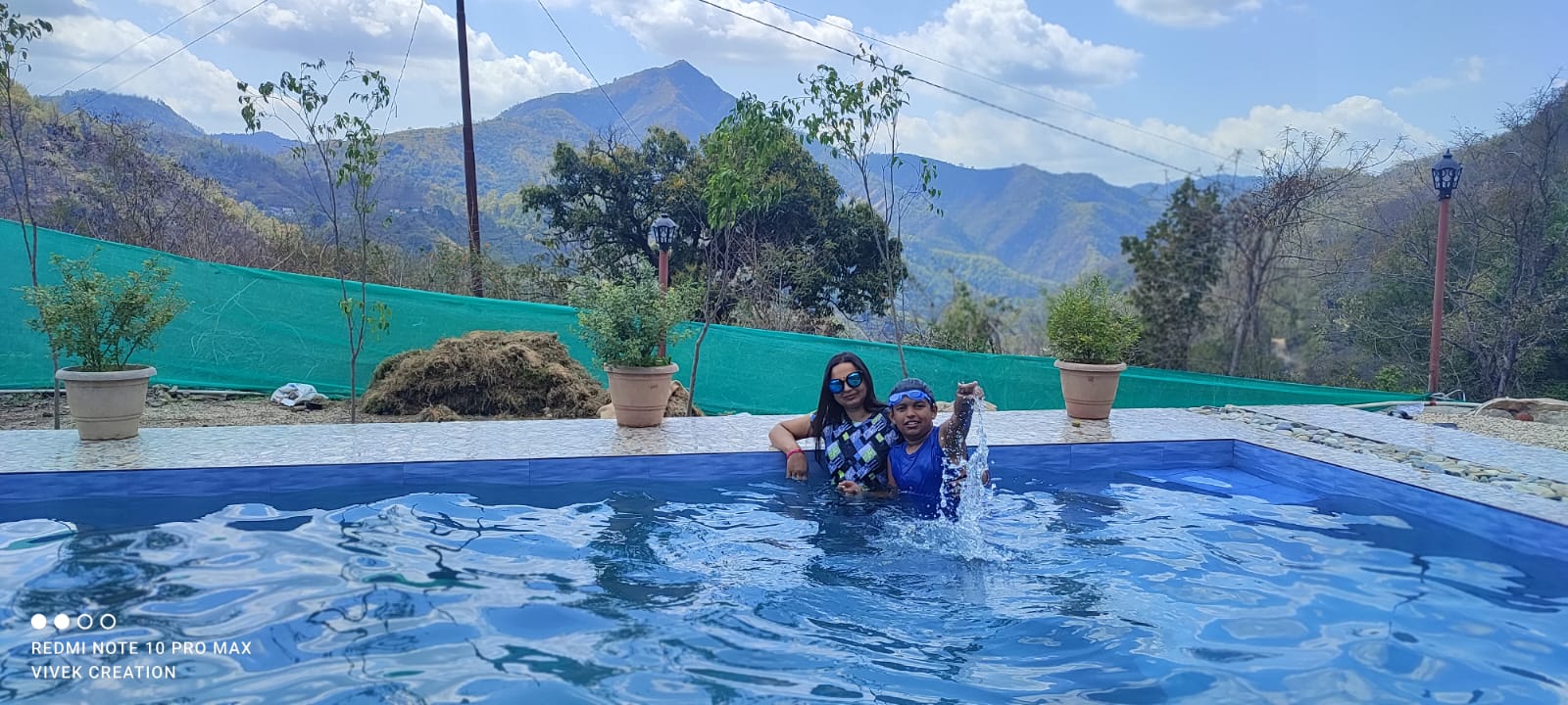 Couples enjoying tea while relaxing in the swimming pool at The Jungle Mist Resort Rishikesh